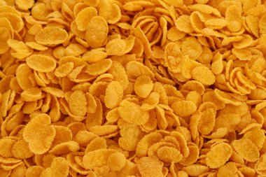 Mısır gevreği arkaplanı ve dokuyu kapatır. Sabah kahvaltısı için mısır gevreği.