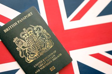KYIV, UKRAINE - SEPTEMBER 17, 2025 Black British passport on UK Union Jack flag close up