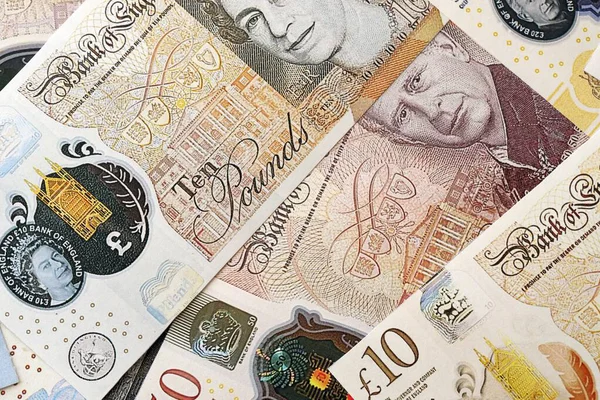 KYIV, UKRAINE - SEPTEMBER 17, 2025 Big amount of British pound money bills on table close up