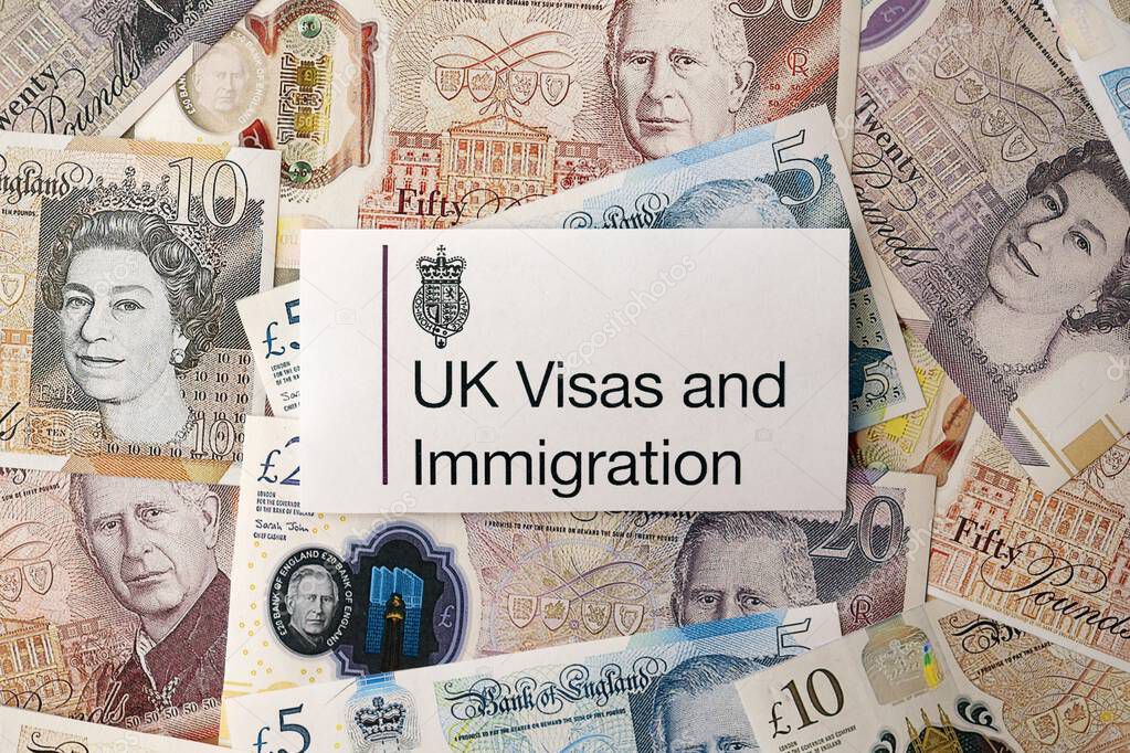 KYIV, UKRAINE - SEPTEMBER 17, 2025 UK Visas and Immigration logotype sticker lies on British pound money close up