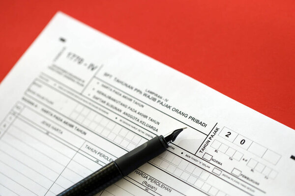 KYIV, UKRAINE - JANUARY 27, 2024 Indonesian tax form 1770-4 Individual Income Tax Return and pen on table close up