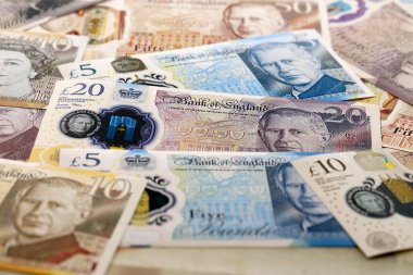 KYIV, UKRAINE - SEPTEMBER 17, 2025 Big pile of British pound money bills on table close up