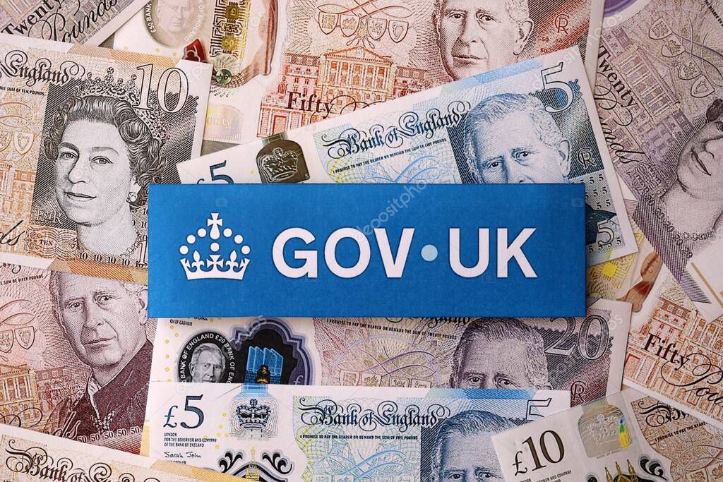 KYIV, UKRAINE - SEPTEMBER 17, 2025 Government GOV UK logotype sticker lies on British pounds money bills close up