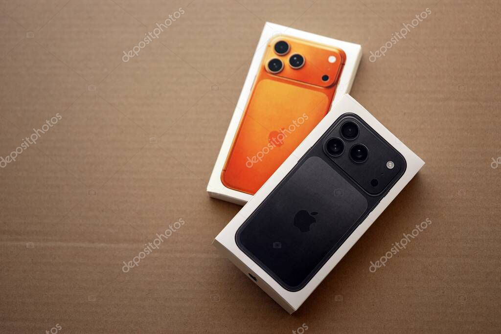 KYIV, UKRAINE - SEPTEMBER 21, 2025 Apple iPhone 17 Pro Max Black box and other iPhone model box on cardboard surface close up