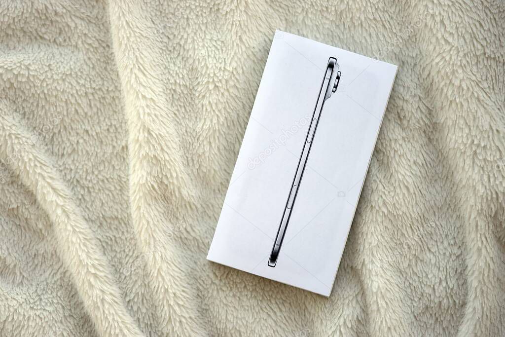 KYIV, UKRAINE - SEPTEMBER 21, 2025 Apple iPhone 17 Slim box on fluffy white plaid close up