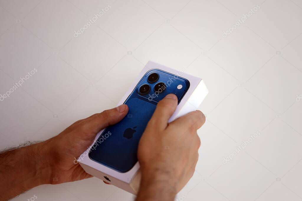 KYIV, UKRAINE - SEPTEMBER 21, 2025 Apple iPhone 17 Pro Max Deep Blue box in male hands in shop close up