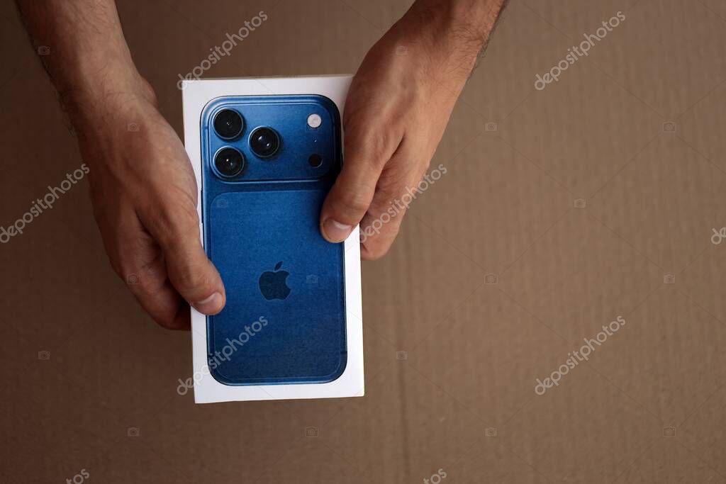 KYIV, UKRAINE - SEPTEMBER 21, 2025 Apple iPhone 17 Pro Max Deep Blue box in male hands on table close up