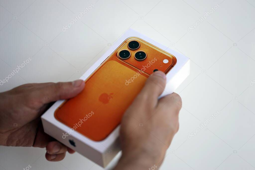 KYIV, UKRAINE - SEPTEMBER 21, 2025 Apple iPhone 17 Pro Max Cosmic Orange box in male hands in shop close up