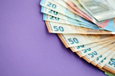 Avrupa para birimi banknotlarının büyük bir kısmı mor renkli masaya yakın. Avrupa 'da iş ve gelir kavramı