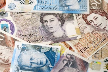 KYIV, UKRAINE - SEPTEMBER 17, 2025 Big amount of British pound money bills on table close up