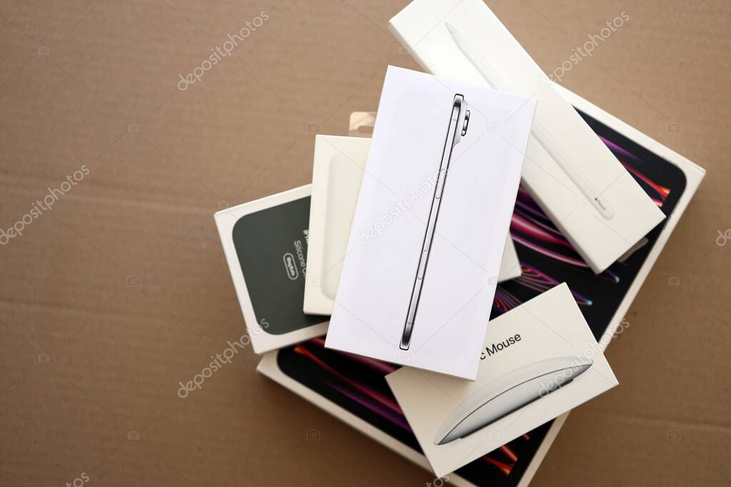 KYIV, UKRAINE - SEPTEMBER 21, 2025 Apple iPhone 17 Slim box and other apple products on cardboard surface close up