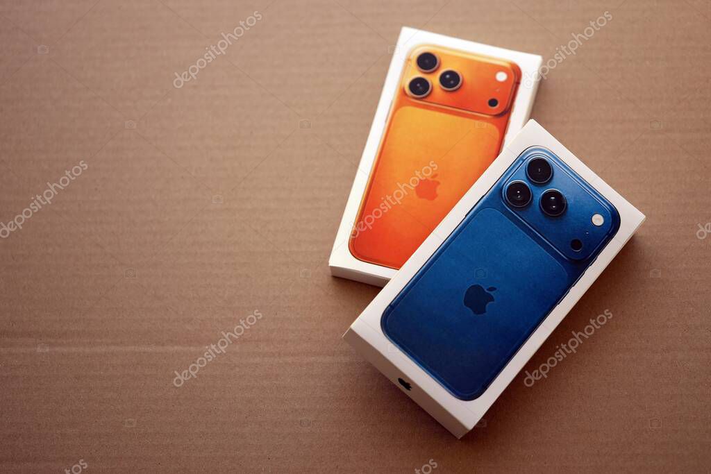 KYIV, UKRAINE - SEPTEMBER 21, 2025 Apple iPhone 17 Pro Max Deep Blue box and other iPhone model box on cardboard surface close up
