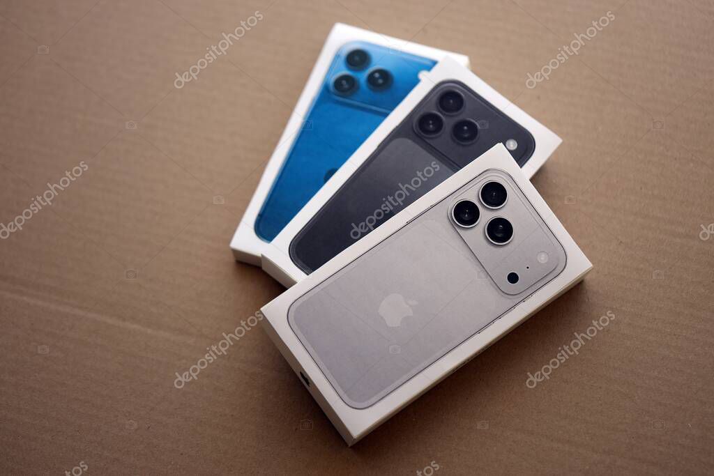 KYIV, UKRAINE - SEPTEMBER 21, 2025 Apple iPhone 17 Pro Max Silver box and other iPhone model box on cardboard surface close up