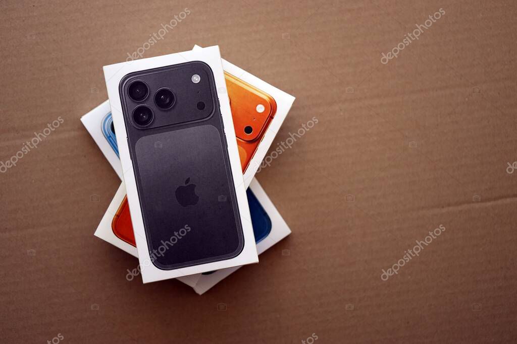 KYIV, UKRAINE - SEPTEMBER 21, 2025 Apple iPhone 17 Pro Max Black box and other iPhone model box on cardboard surface close up
