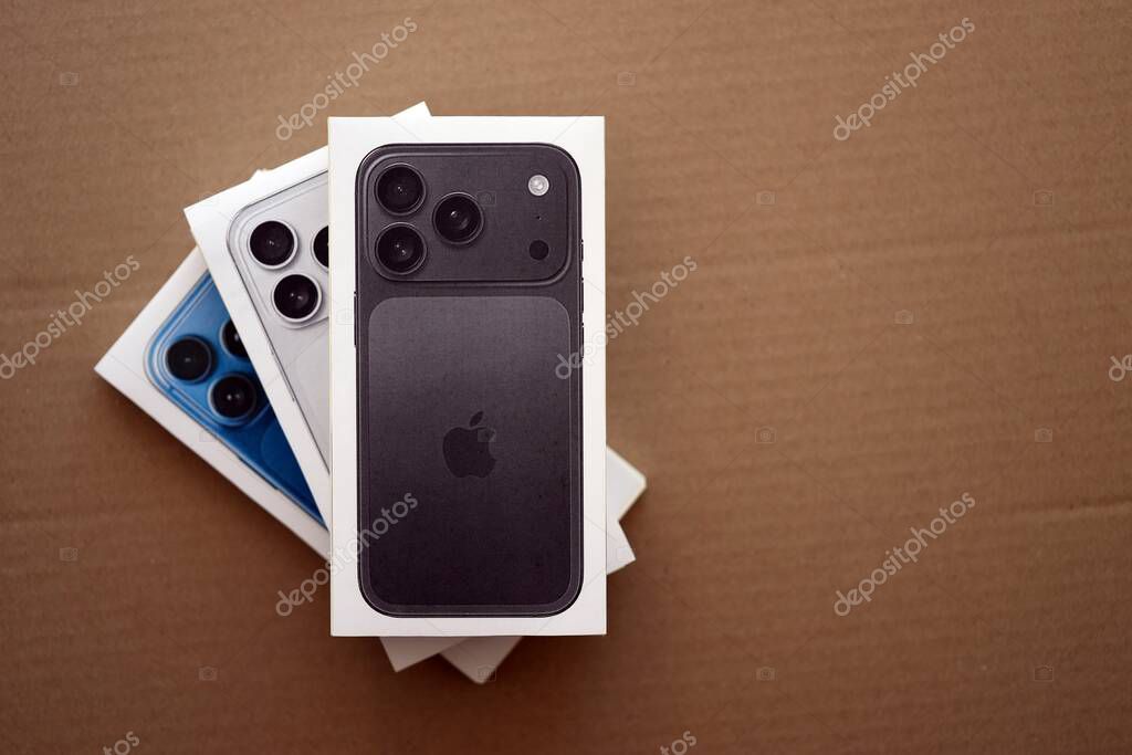 KYIV, UKRAINE - SEPTEMBER 21, 2025 Apple iPhone 17 Pro Max Black box and other iPhone model box on cardboard surface close up