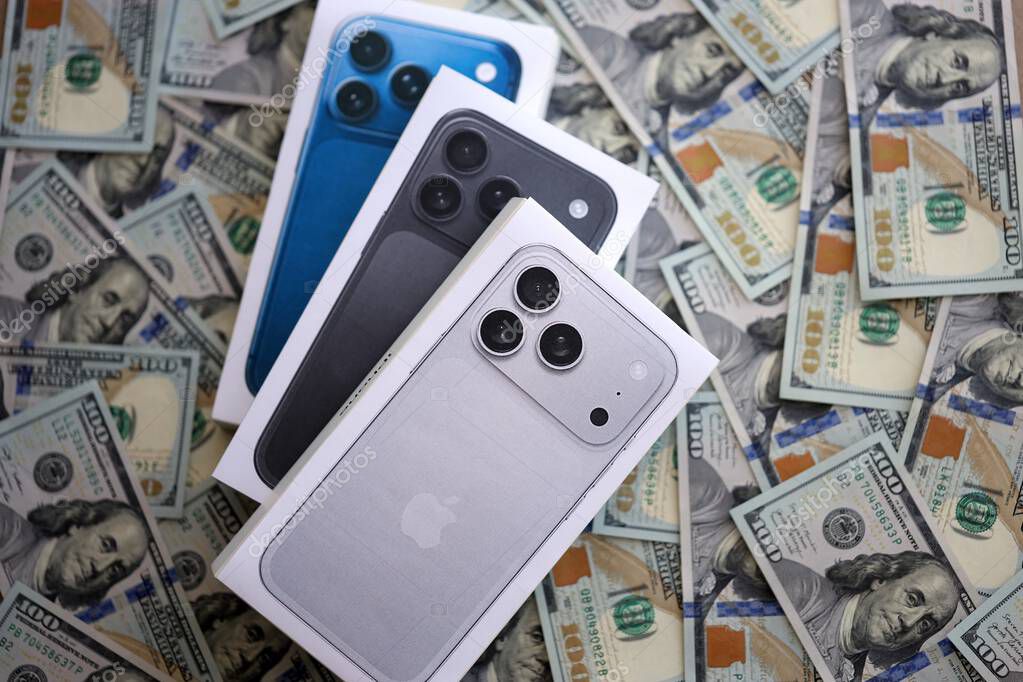 KYIV, UKRAINE - SEPTEMBER 21, 2025 Apple iPhone 17 Slim box on big amount of US dollar bills close up