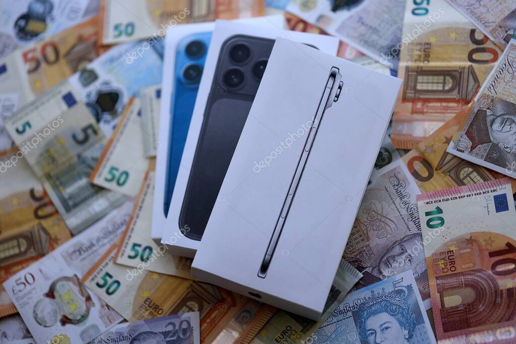 KYIV, UKRAINE - SEPTEMBER 21, 2025 Apple iPhone 17 Slim box on big amount of GB pounds and euro bills close up