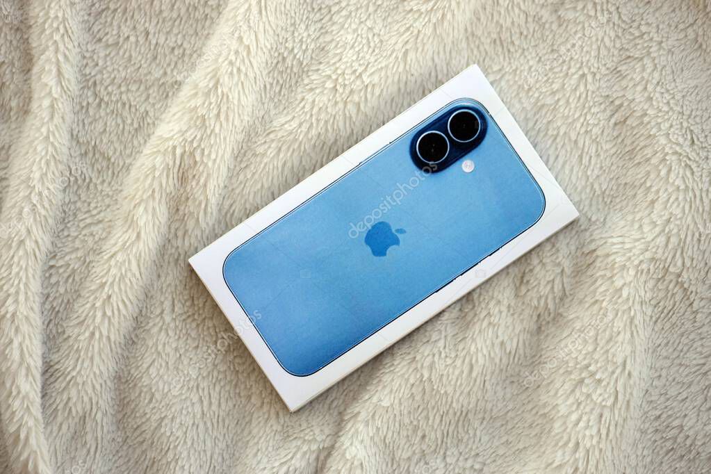 KYIV, UKRAINE - SEPTEMBER 21, 2025 Apple iPhone 17 Mist Blue box on fluffy white plaid close up