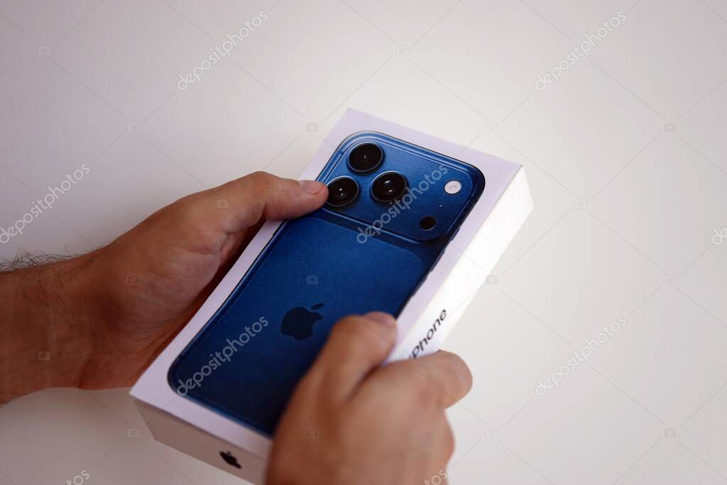 KYIV, UKRAINE - SEPTEMBER 21, 2025 Apple iPhone 17 Pro Max Deep Blue box in male hands in shop close up