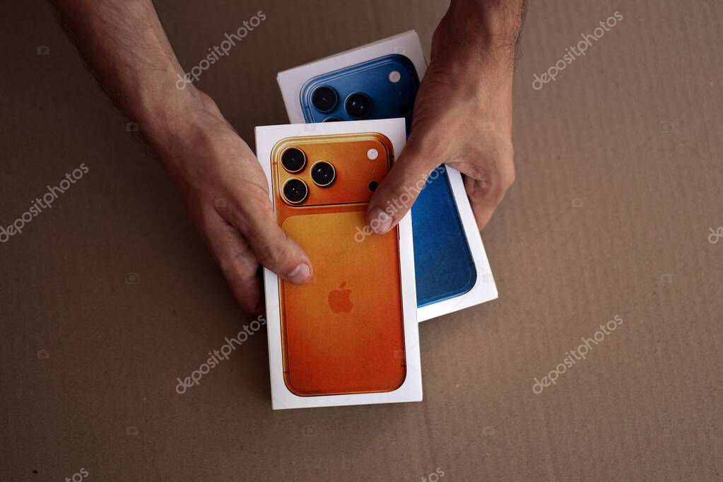 KYIV, UKRAINE - SEPTEMBER 21, 2025 Apple iPhone 17 Pro Max Cosmic Orange box in male hands on table close up