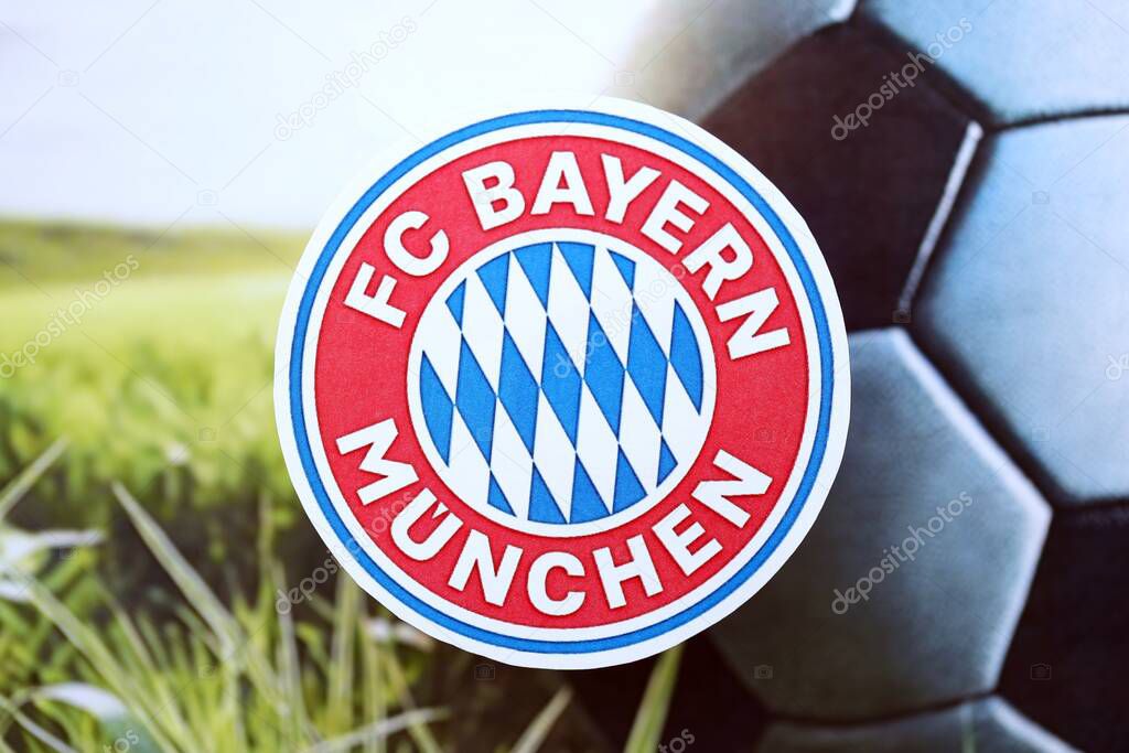 KYIV, UKRAINE - FEBRUARY 23, 2025 FC Bayern Munich football club badge lies on soccer ball background banner