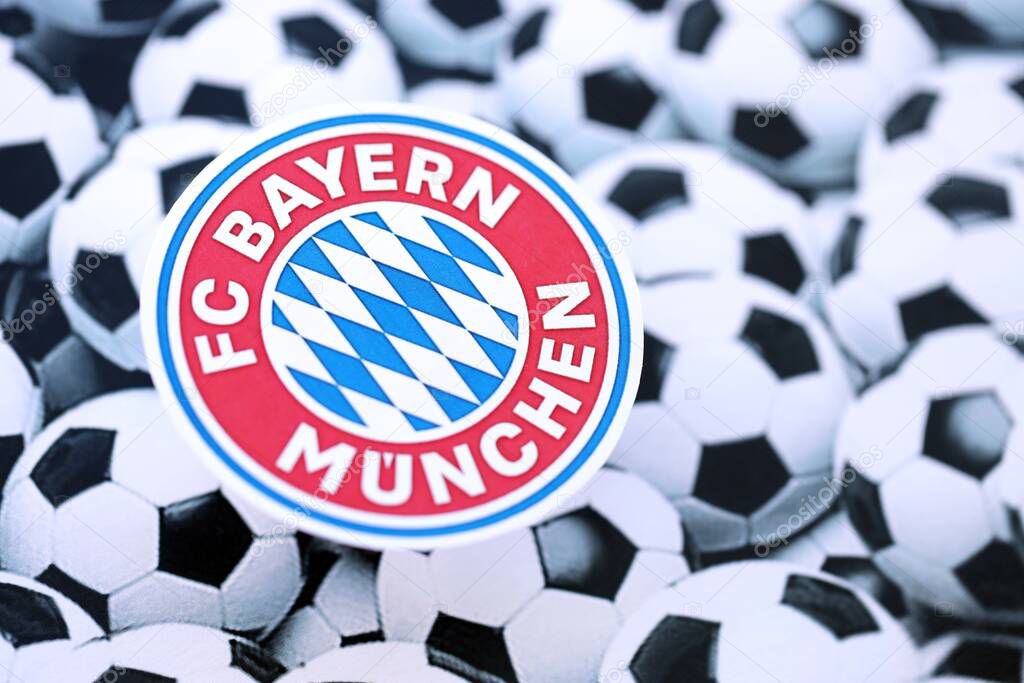 KYIV, UKRAINE - FEBRUARY 23, 2025 FC Bayern Munich football club badge lies on soccer balls background banner