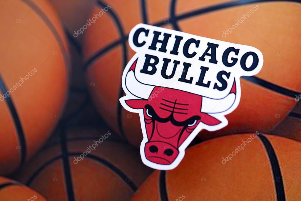 KYIV, UKRAINE - FEBRUARY 23, 2025 Chicago Bulls basketball team badge lies on basketball balls background banner
