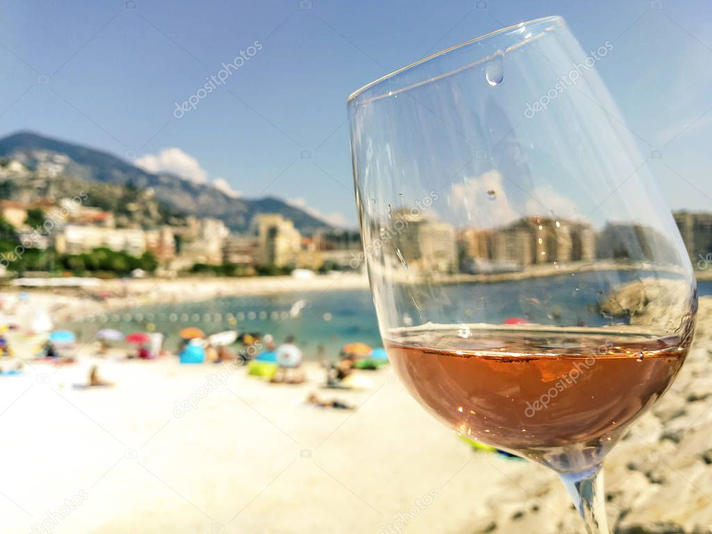 Glass of rose wine on the seacoast of the French Riviera