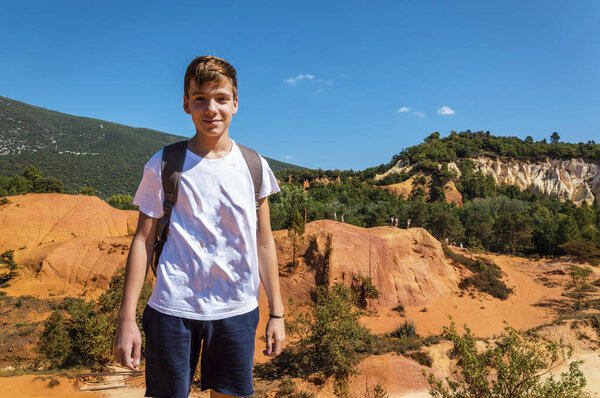Young boy in ocher lands in the Rustrel nature park