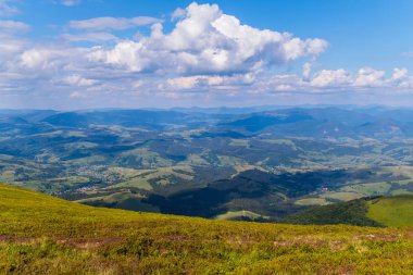 En uzak yeşil tepeler ve köyün aralarında bakan, gözlem güvertesinde