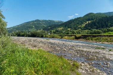 Güzel bir kırsal köy zemin karşı bir sığ dağ nehir bir ısmarlayarak