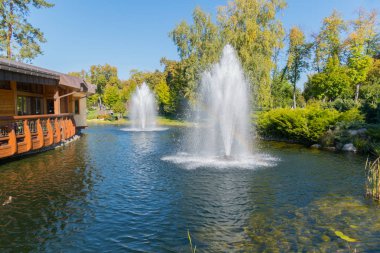 Göl sokakları yürüme ile yeşil park bölgesi yakınındaki yüksek gür çeşmeler ile