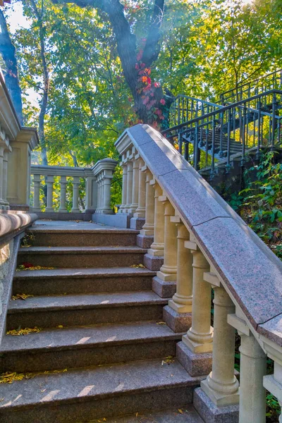 A multi-level ladder with beautiful railings in the form of columns leading up