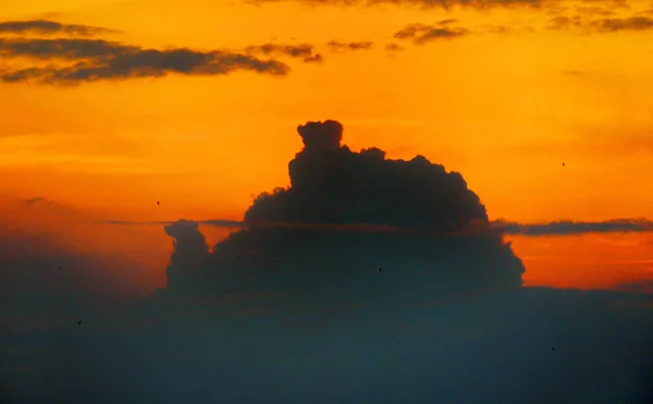 Orange sky in the west with a shadow of a large cloud — Stock Photo, Image