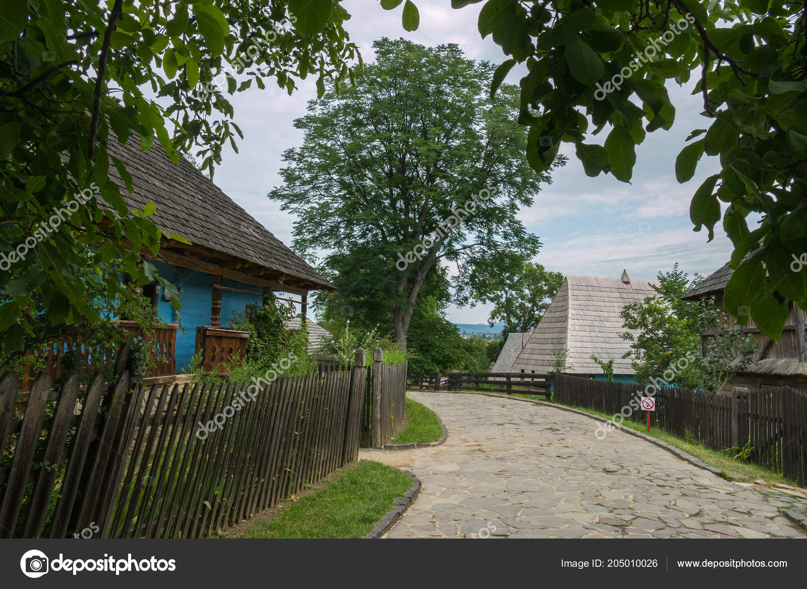 Stone Alley In Shevchenkos Grove Near A Blue Wooden House Stock
