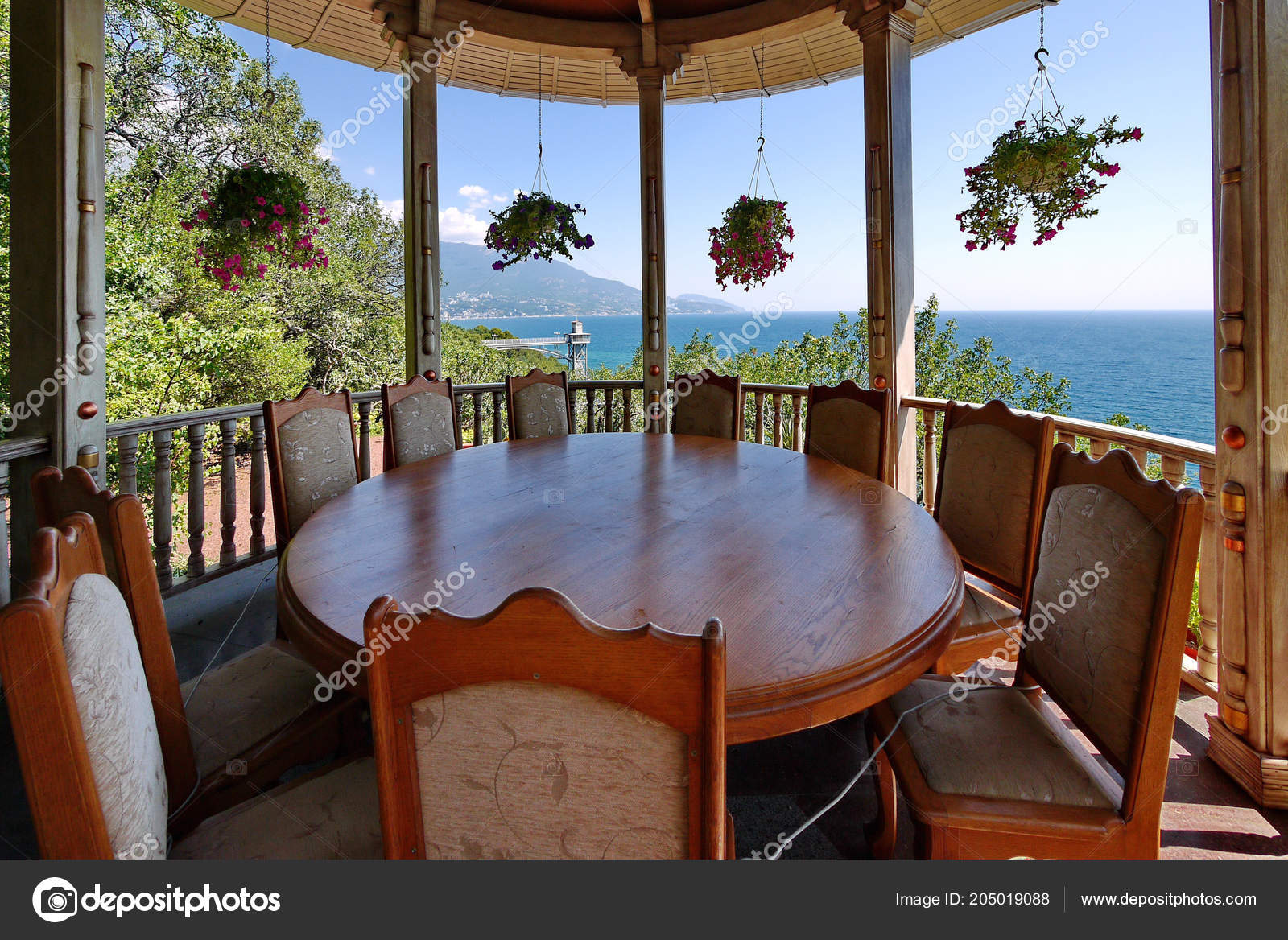 A Massive Round Wooden Table With Chairs Standing In A