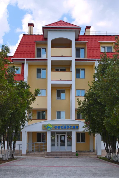 Уютный бежевый пятиэтажный пансион с большими балконами и красной крышей — стоковое фото