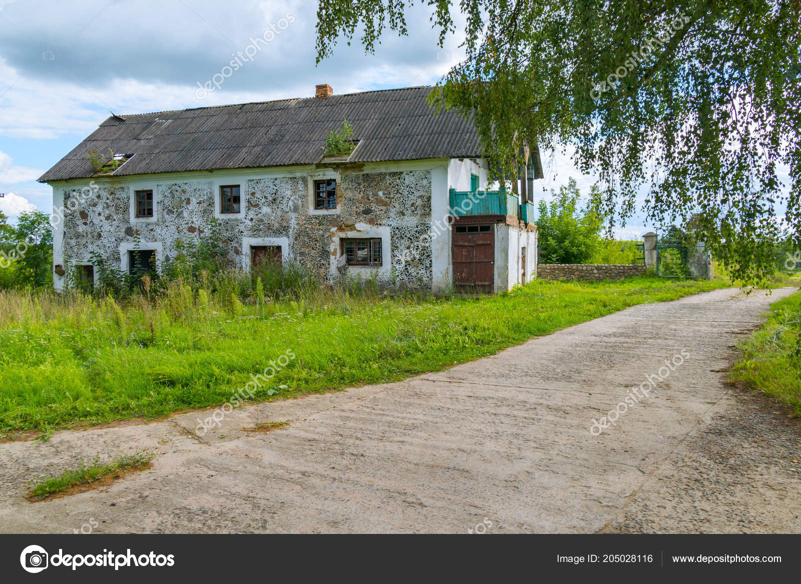 A Long Wide Road Is Surrounded By Grass On The Background Of