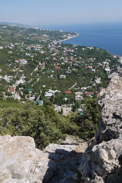 Небольшой камень на фоне красивого тихого прибрежного городка под голубым небом — стоковое фото