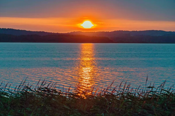 Mar calmo no fundo de um belo pôr do sol fogo — Fotografia de Stock