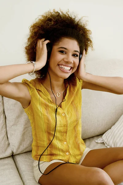 beautiful smiling girl listen music with earbud at home