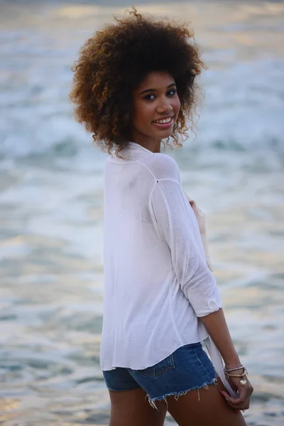 beautiful woman portrait  with afro hair relax  at sunset on the sea