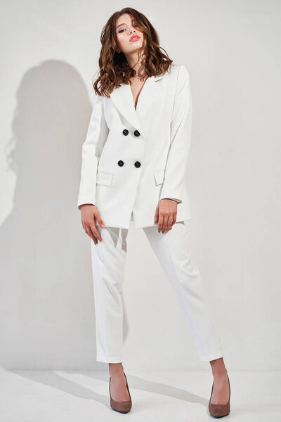 Young elegant woman in trendy white coat