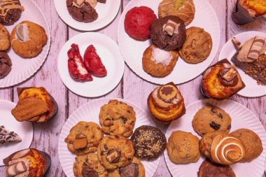 % 70 'lik büyük kakao parçalarıyla nefis siyah çikolatalı kurabiyeler, kırsal ahşap bir tahtanın üzerine gevrek deniz tuzu serpiştirilmiş..