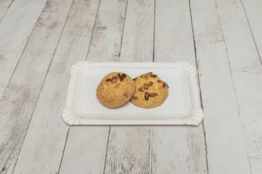 Klasik tereyağlı kurabiyeler, beyaz çikolata parçacıkları ve doğranmış cevizler kenarlarında altın rengi kahverengi ve ortasında da hassas..