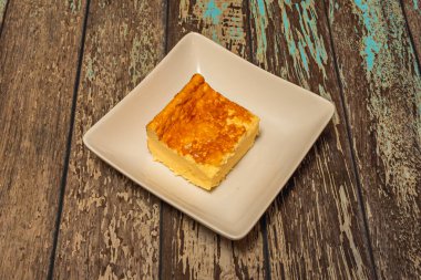  cheesecake with a crushed chocolate biscuit base, a cheese and  hunk filling, and a cream topping with a whole biscuit