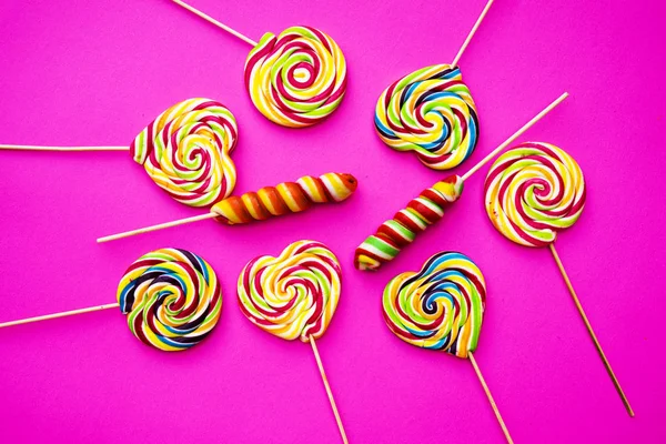 Rainbow Lollipop Swirl Wooden Stick Pink Paper Background Flat Lay — Stock Photo, Image