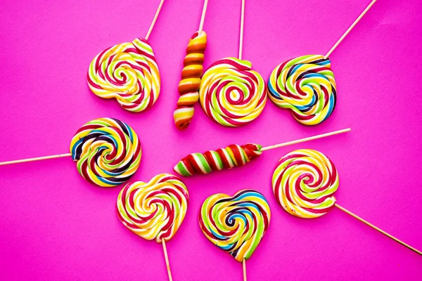 Rainbow Lollipop Swirl Wooden Stick Pink Paper Background Flat Lay — 스톡 사진