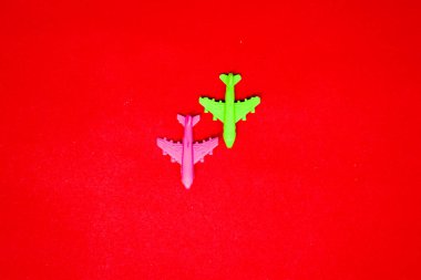 Flat lay of miniature toy airplane on pastel red background minimal trip and travel creative concepts. copy space