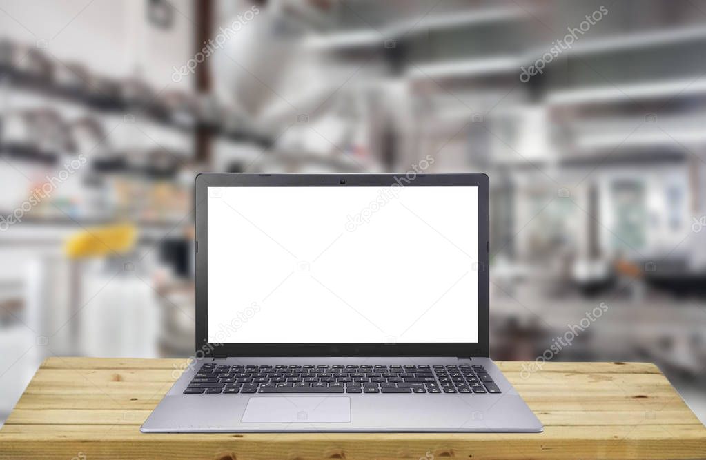 Product display Concept. Empty Screen of laptop over brown wooden table for product display montage kitchen desk.